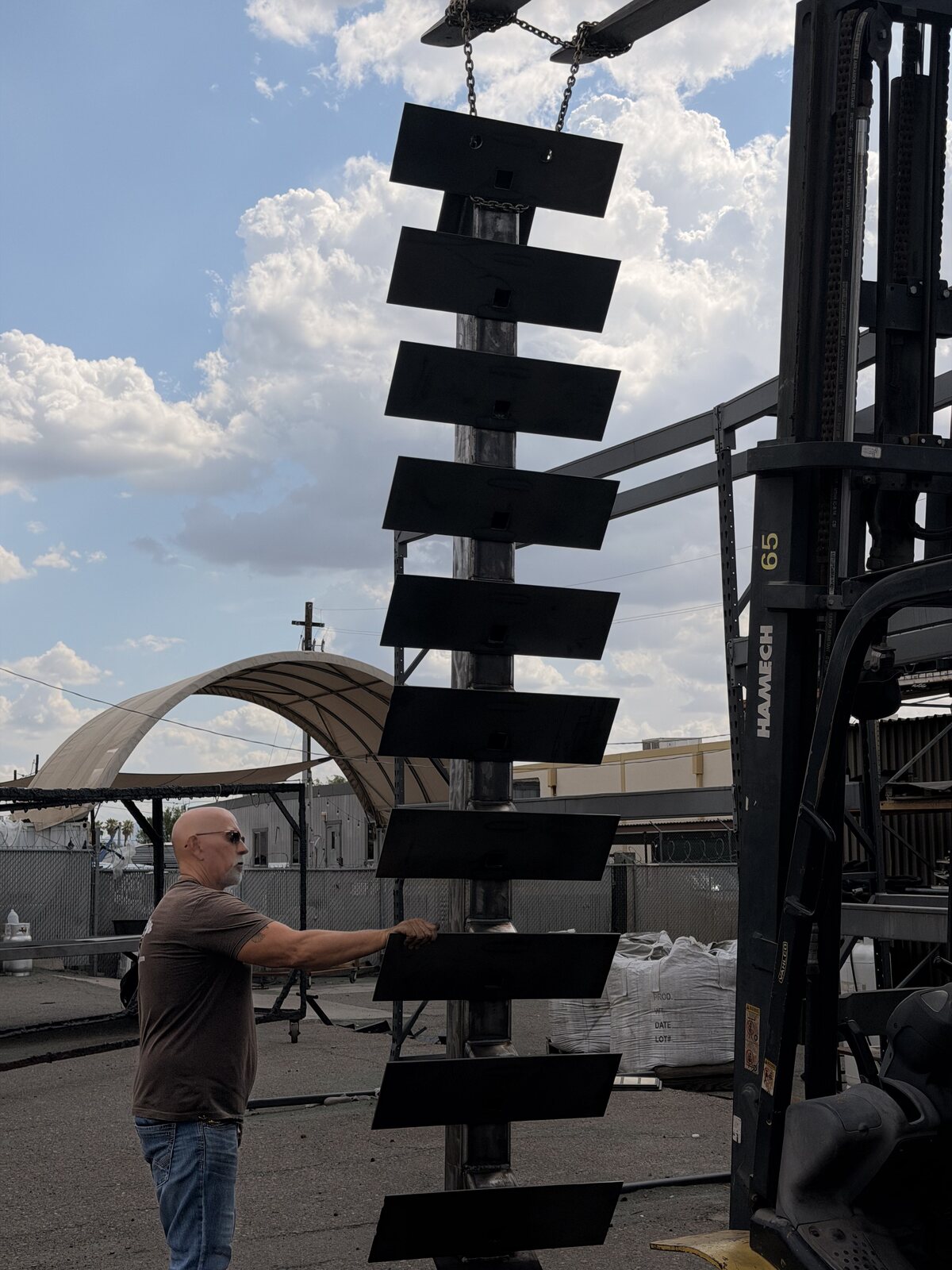 Floating steel staircase treads set in place with a forklift at the job site