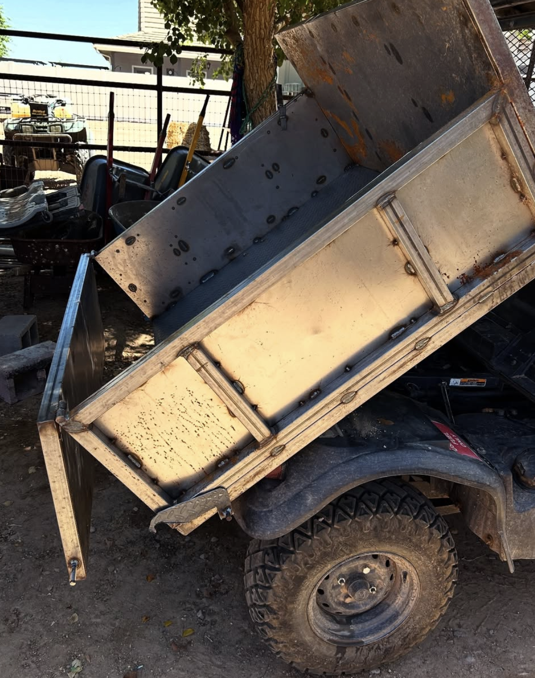 Rebuilt and reinforced steel dump bed for a utility vehicle