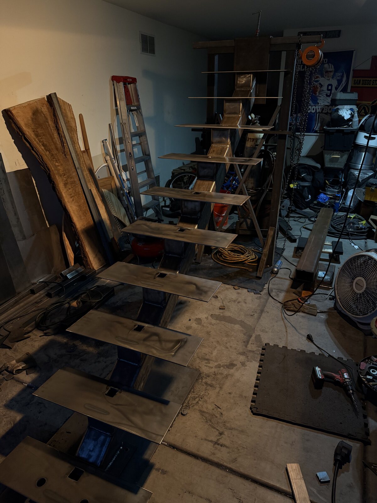 Steel staircase stringer with treads tacked in place inside the shop